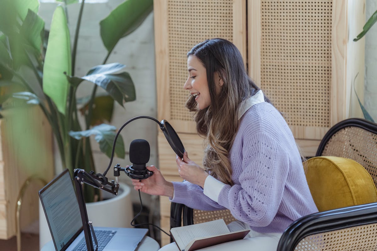 Creator recording content beside a laptop